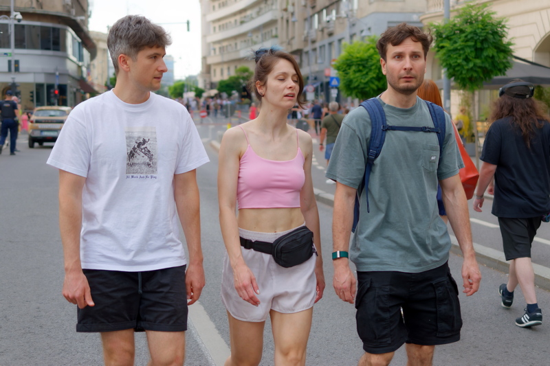 5 - Three young people walking together on a street in Bucharest